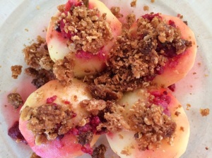 Poach apples with spices, sprinkle with warmed frozen raspberries and crushed crumble topping cooked on an oven tray. Serve with whipped cream.